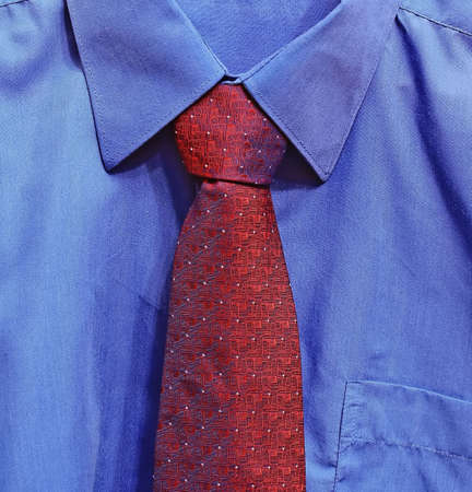 Fragment of masculine clothes. Dark blue shirt and large red tie. の写真素材