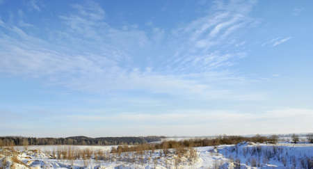 Winter landscape, snow field, beautiful relief from hills and ravines, light, blue, cold sky. の写真素材