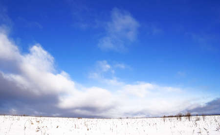 Winter landscape, the Heavy dark clouds fill high quickly, bright, more dark blue, sky. A weather will change soon, will be snow, will become gloomy coldly. の写真素材