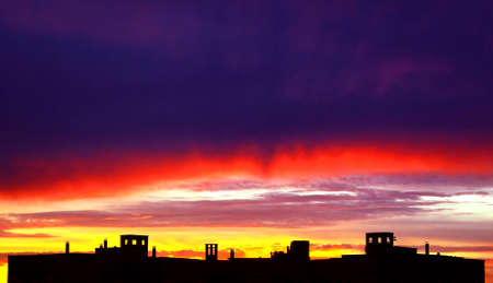 Evening view. Bright red sunset, conceals dark, heavy cloud. の写真素材