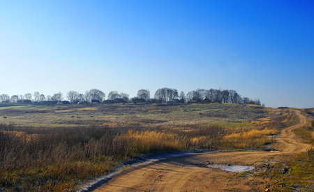 Russian rural landscape, a village on the hill first ice, sunny morning. 
