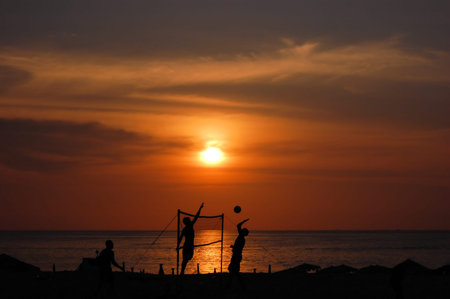 beach volleyball played on a beach at sunset の写真素材