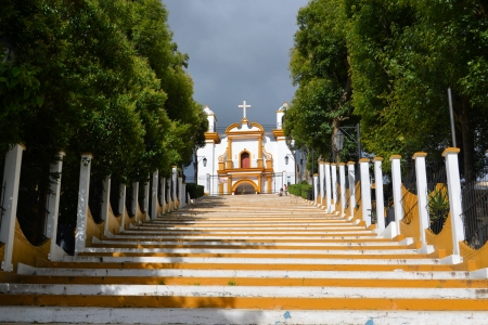 A Christian Catholic chapel on a hill with colorful steps in San Cristobal de las Casas, Chiapas, Mexicoの写真素材