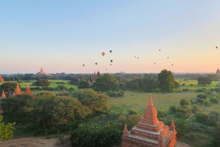 Balloons flying over Buddhist pagodas at Bagans ancient temples in Northern Myanmar, Burmaの写真素材