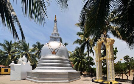 Buddhist Stupa under palm trees on Nainativu island near Jaffna in Indian Ocean, Sri Lanka, erected by Sri Lankan army after capitulation of Tamil Tigersの写真素材