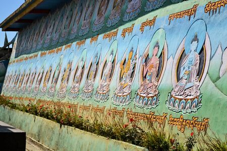 Colorful depictions of Buddha on the outside of a Buddhist temple near Singalila, Nepalの写真素材