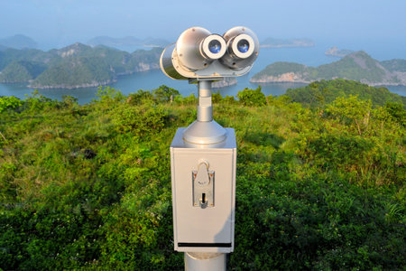Coin operated telescope binoculars at a scenic lookout on the Vietnamese island Cat Ba, overlooking...