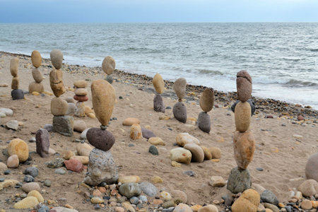 Rocks and Pebbles towers balanced in Zen style at the shores of the ocean