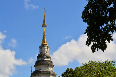 Buddhas Face looks in all cardinal directions from a Stupa at a Buddhist temple, Chiang Mai,...