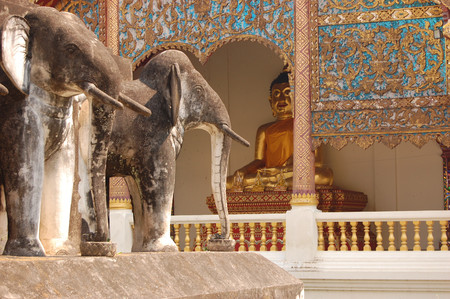 Stucco sculpture elephant in front of Buddha statue at Wat Chiang Man. Chiang Mai, Thailandのeditorial素材