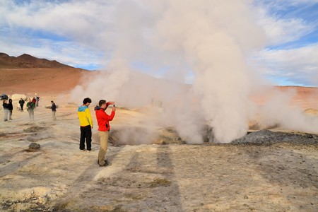 Uyuni, Bolivia - 28 November 2012: Tourists at a geysir in Eduardo Avaroa National Park. Southwestern Bolivia is well-known for dramatic landscapes, lagunas, geysirs, desert and volcanoesのeditorial素材