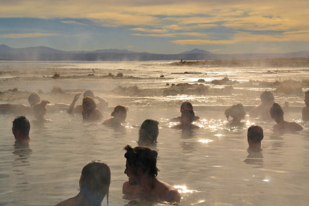 Uyuni, Bolivia - 28 November 2012: Tourists take a pathin hot springs in Eduardo Avaroa National Park. Southwestern Bolivia is well-known for dramatic landscapes, lagunas, geysirs, desert and volcanoesのeditorial素材