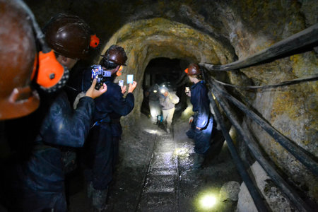 Potosi, Bolivia - 24 November 2012: Tourists inside the Cerror Rico silver mine film miners...