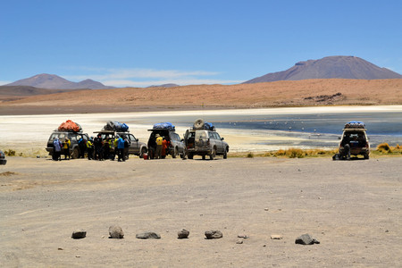 Uyuni, Bolivia - 27 November 2012: Tourist Jeeps stop for a break and Sightseeing at Laguna Verde in Eduardo Avaroa National Park. Southwestern Bolivia is well-known for dramatic landscapes, lagunas, geysirs, desert and volcanoesのeditorial素材