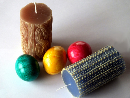 Two blue and brown candles with three eastereggs Two blue and brown candles with three eastereggs
