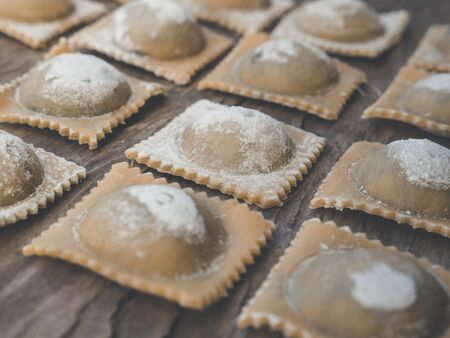 regional fresh handmade food and pasta like ravioli on wooden rustic backgroundの写真素材
