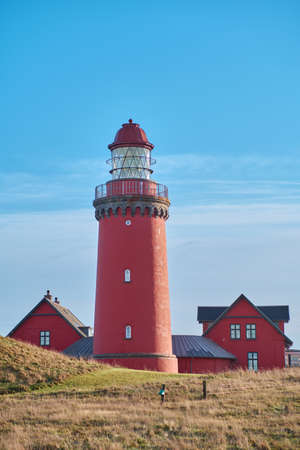 Red lighthouse at the danish coast called Bovbjerg Fyrの写真素材