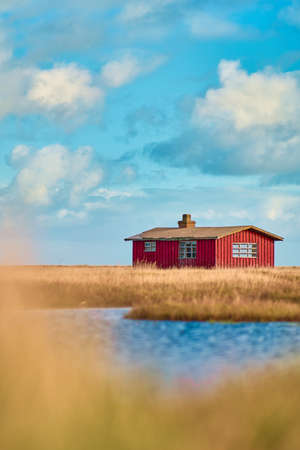 Red hut at the sea in Denmarkの写真素材