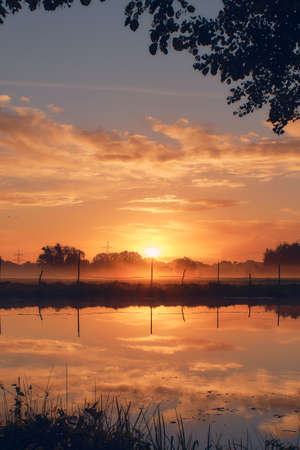 Small Pond and Field at sunriseの写真素材