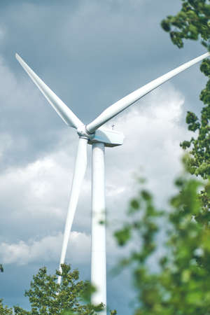Wind Turbine in Germany with Tree in the Foregroundの写真素材