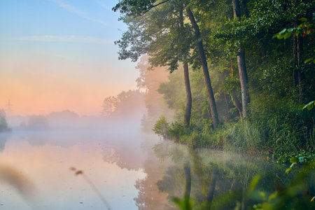 Morning fog over calm lake