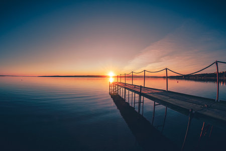 Jetty in the Sunrise at Limfjord in Denmarkの写真素材