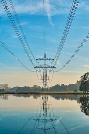 Power line in rural area with lake