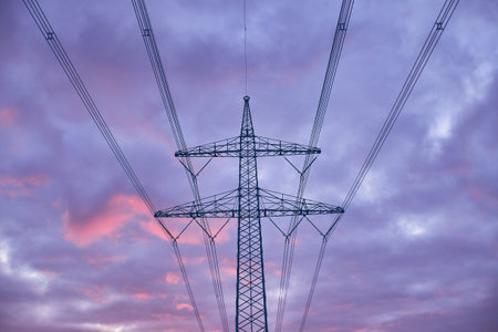 Power line against colorful evening sky