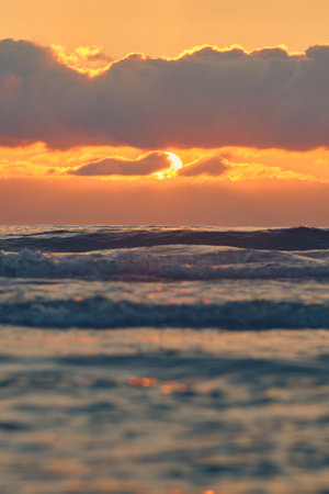 Setting sun over north sea coastの写真素材