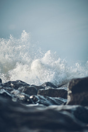 Wave hitting rocks at the shore of Denmark