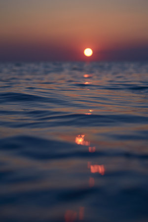 Setting sun reflecting in north sea waterの写真素材