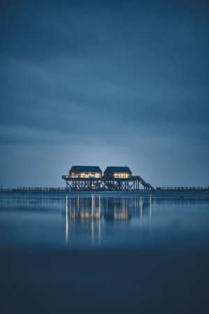 stilt house at sankt peter-ording germany at duskの写真素材