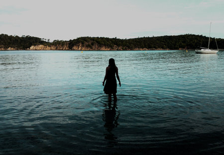 Young woman walking in waterの写真素材