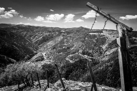 Old socialist border with barbed fence in mountains
