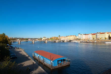 View of the historic city center of Prague from a bank of the Vltava on a cloudless day. The sky is azure blue.の写真素材