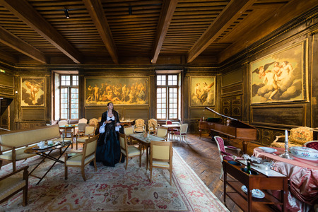 Sassenage castle, Isere, France - September 15 2018 : European Heritage Day, Women tour guide with ancient clothes in the main room with paintings and wooden ceiling.のeditorial素材