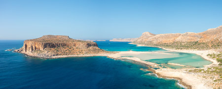 Expansive panoramic view of Balos Beach in Crete, Greece, showcasing vivid turquoise lagoons, rugged...
