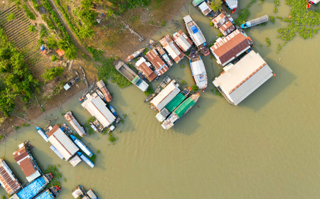 Top-down aerial view of a floating village along the river in Chau Doc, Vietnam, with clusters of...