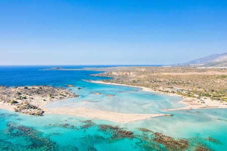 Expansive aerial image of Elafonisi beach in Crete, Greece, showcasing a vivid turquoise lagoon,...