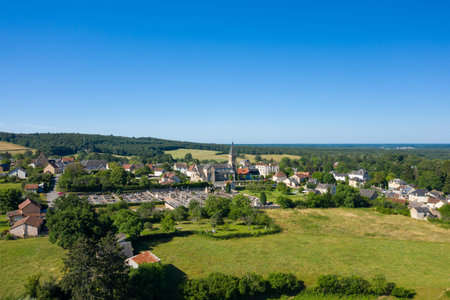 Elevated view of Saint-Honore-les-Bains featuring a central church with a cemetery, surrounded by...