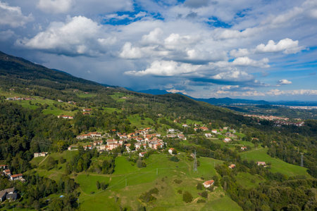 Wide aerial perspective of Ceresito, a rural Italian village set among lush green hills and...