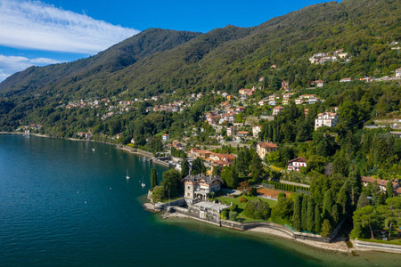 Aerial view of elegant hillside villas and lush gardens lining the shore of Lake Maggiore in...