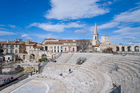 Arles, France - April 1, 2023: The image shows the curved stone seating tiers of the Ancient Theatre...
