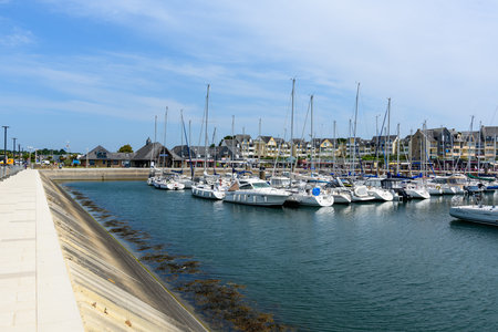 Arzon, France - May 29, 2023: Numerous sailboats and motorboats are moored in a marina, with...