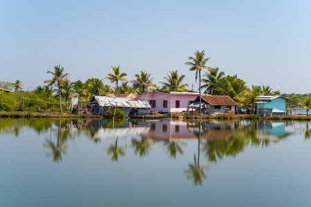Munroe Island, India - March 4, 2023: Several houses with metal and tiled roofs are situated along...