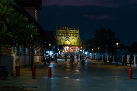 Trivandrum, India - February 28, 2023: People are seen walking and gathering along the illuminated pathway leading to the gopuram of Sree Padmanabhaswamy Temple at night.のeditorial素材