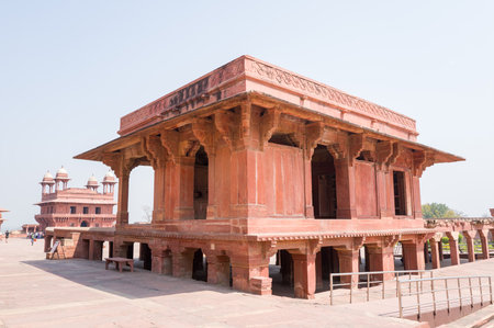Fatehpur Sikri, India - March 12, 2024: The image shows a red sandstone Mughal architectural building situated in the middle of the Pachisi courtyard at Jodha Bai Palace in Fatehpur Sikri, with colonnades and another pavilion visible in the background.のeditorial素材