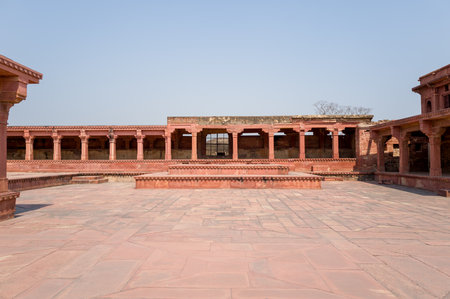 Fatehpur Sikri, India - March 12, 2024: The image shows the central paved courtyard of Jodha Bai Palace with surrounding red sandstone colonnades, raised platforms, and open sky above.のeditorial素材