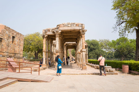 Delhi, India - March 30, 2024: The image shows a stone arcade with multiple columns and arched...