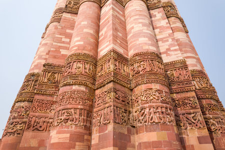 Delhi, India - March 30, 2024: The image shows a detailed view of the red sandstone surface of the...
